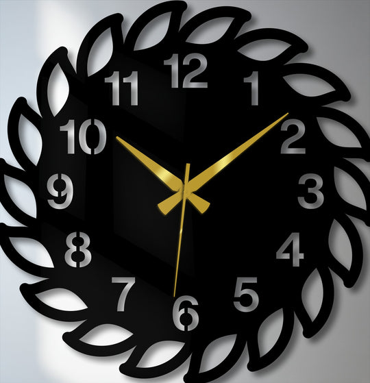 Minimal color saturation highlights the sleek, black decorative leaf frame of this modern nature-inspired metal wall clock, a unique metal wall art piece.