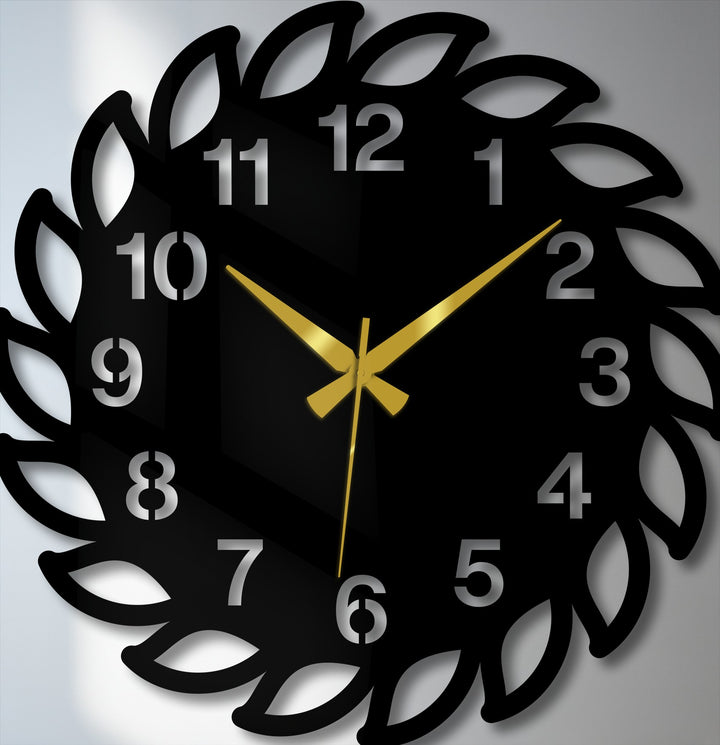Minimal color saturation highlights the sleek, black decorative leaf frame of this modern nature-inspired metal wall clock, a unique metal wall art piece.