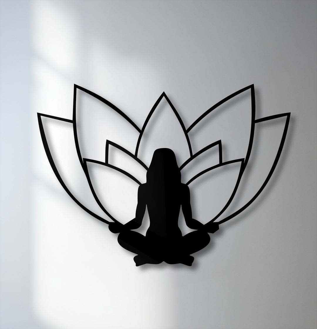 High-quality black metal wall decor featuring a serene lotus meditation silhouette casts elegant shadows on a bright white wall.