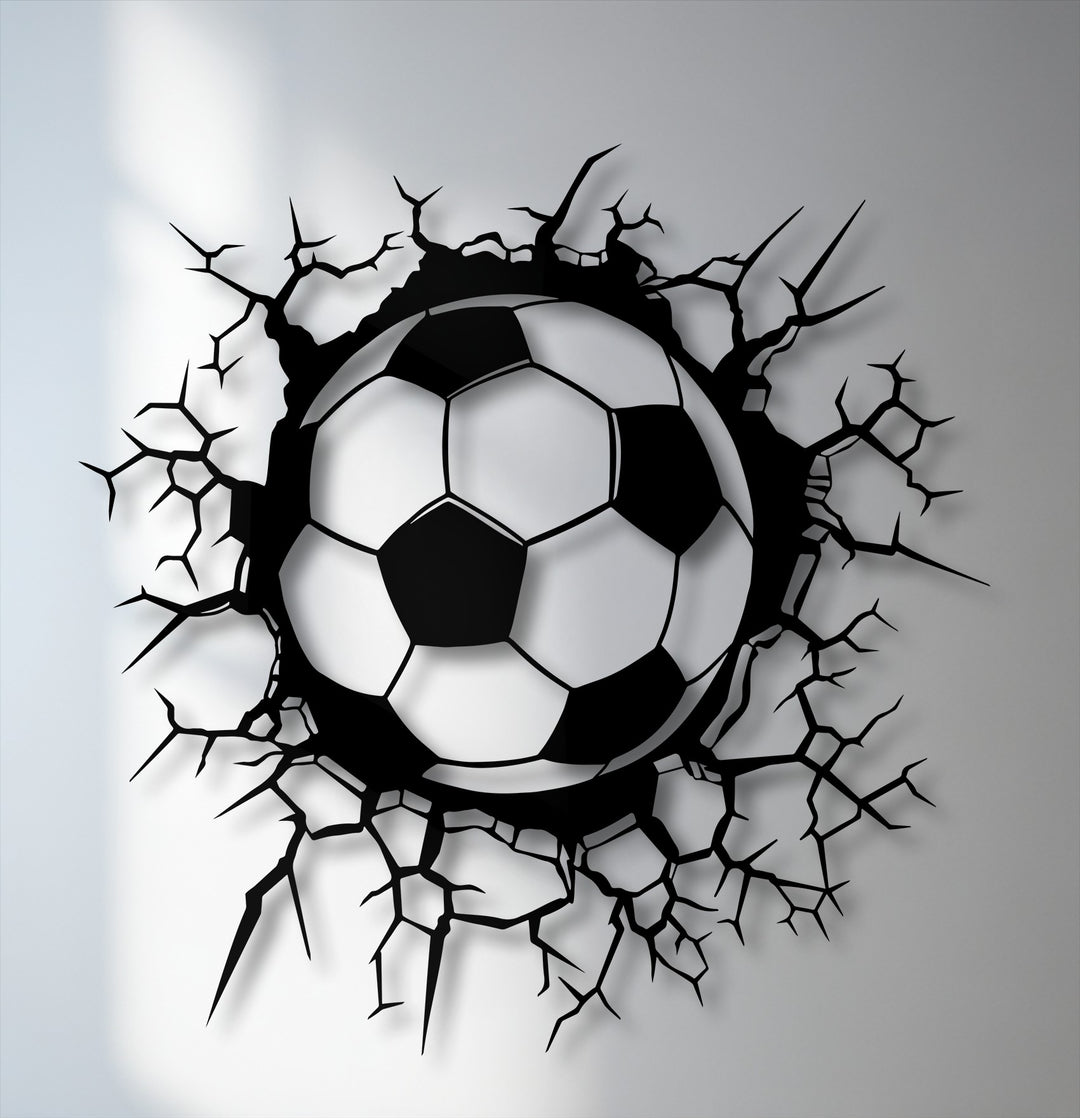 The gently shaded soccer ball, the softest element, bursts through jagged breaking wall metal artwork, showcasing dynamic sports energy.