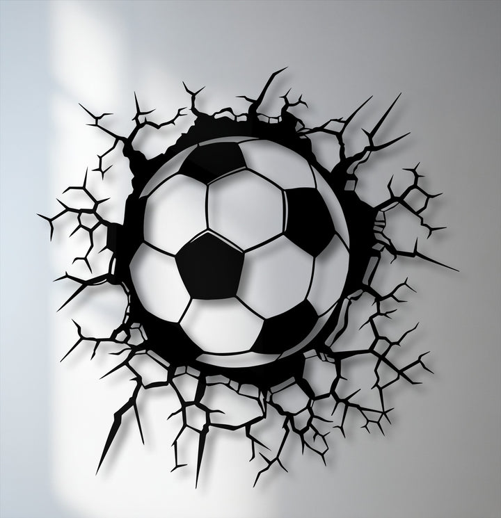 The gently shaded soccer ball, the softest element, bursts through jagged breaking wall metal artwork, showcasing dynamic sports energy.