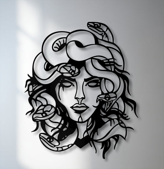 The sleek, matte surface texture of the unique metal wall art featuring Medusa, a mythological snake goddess, casts a sharp shadow against the wall.