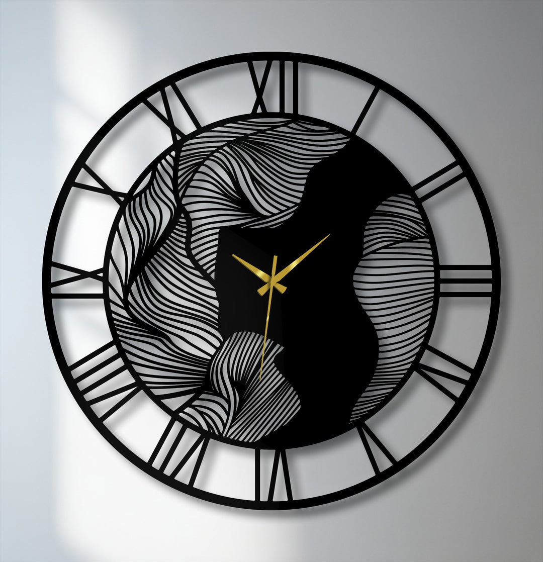 Smooth, undulating lines of decorative wall art create an abstract wave design in this modern metal wall clock featuring elegant Roman numerals and gold hands.
