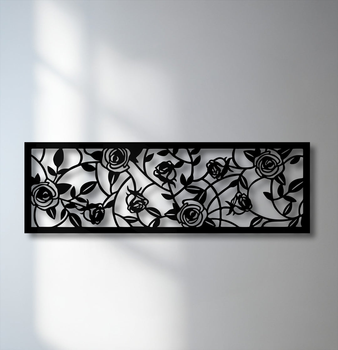 The unique metal wall art showcases a dramatic color contrast with stark black rose and vine details against a crisp white background.