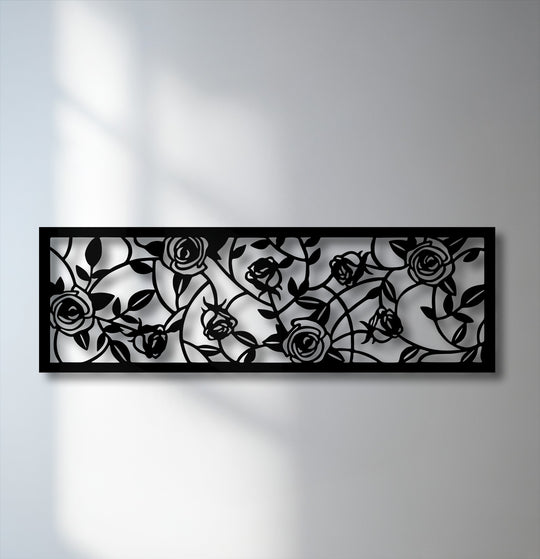 The unique metal wall art showcases a dramatic color contrast with stark black rose and vine details against a crisp white background.