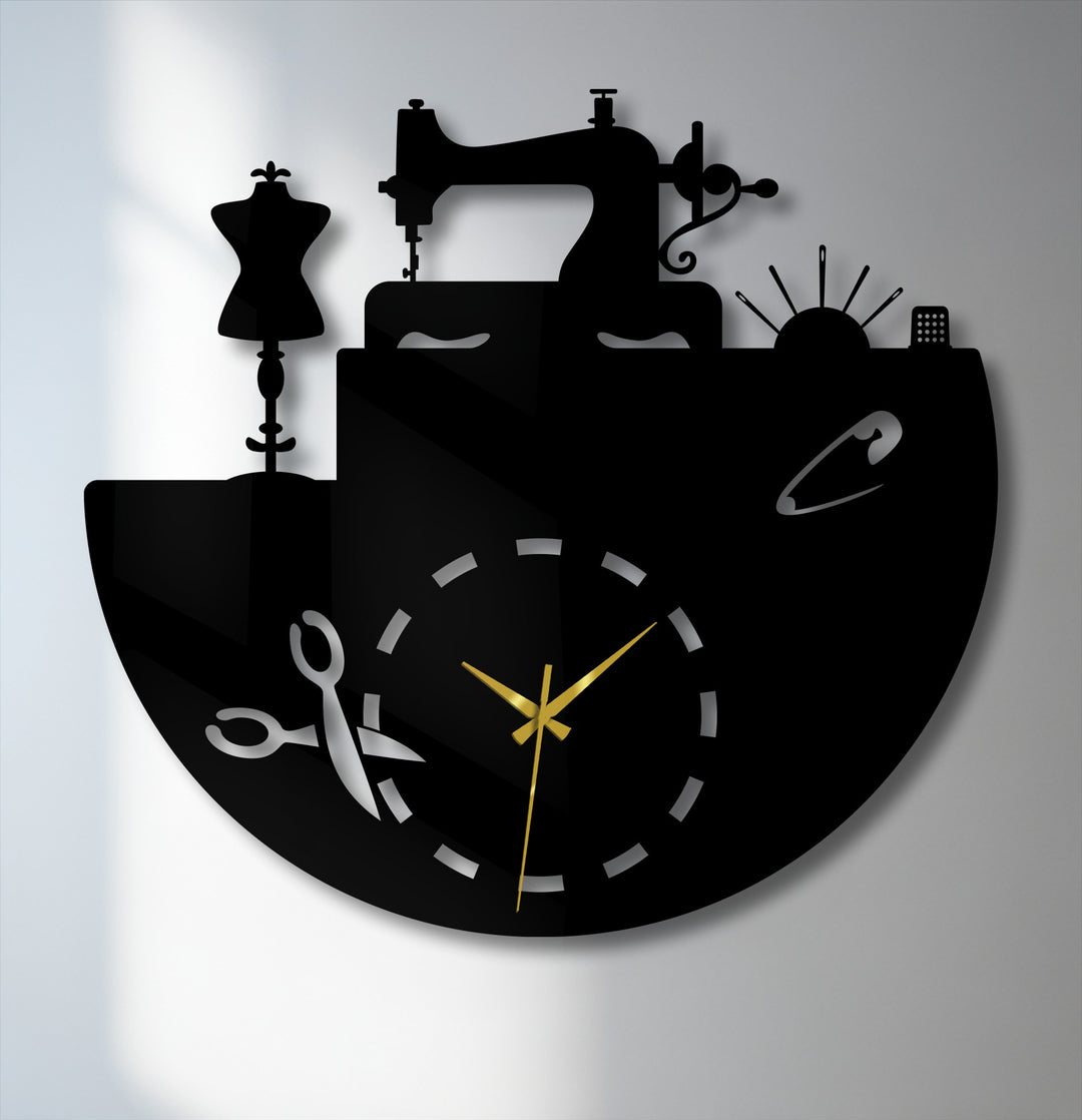 The stark color contrast of this unique metal wall art highlights the black sewing atelier clock against a light wall, featuring luminous gold hands.