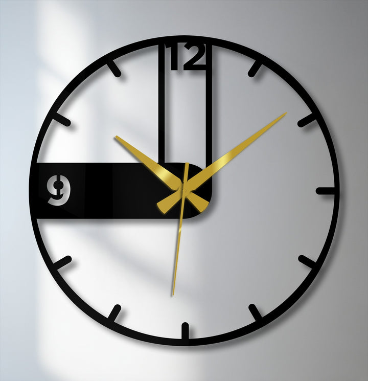 Bold gold hands emphasize the time on this modern asymmetrical black metal artwork clock, a contemporary decorative piece perfect for minimalist spaces.
