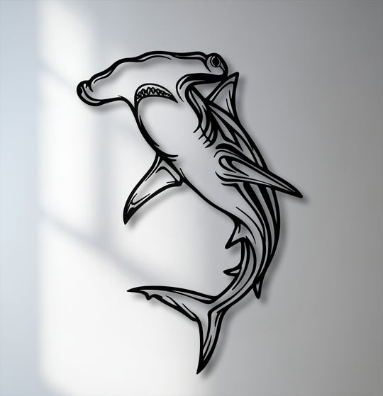 The focal point is a stylized hammerhead shark, a unique metal wall art piece casting a dramatic shadow on the light wall.
