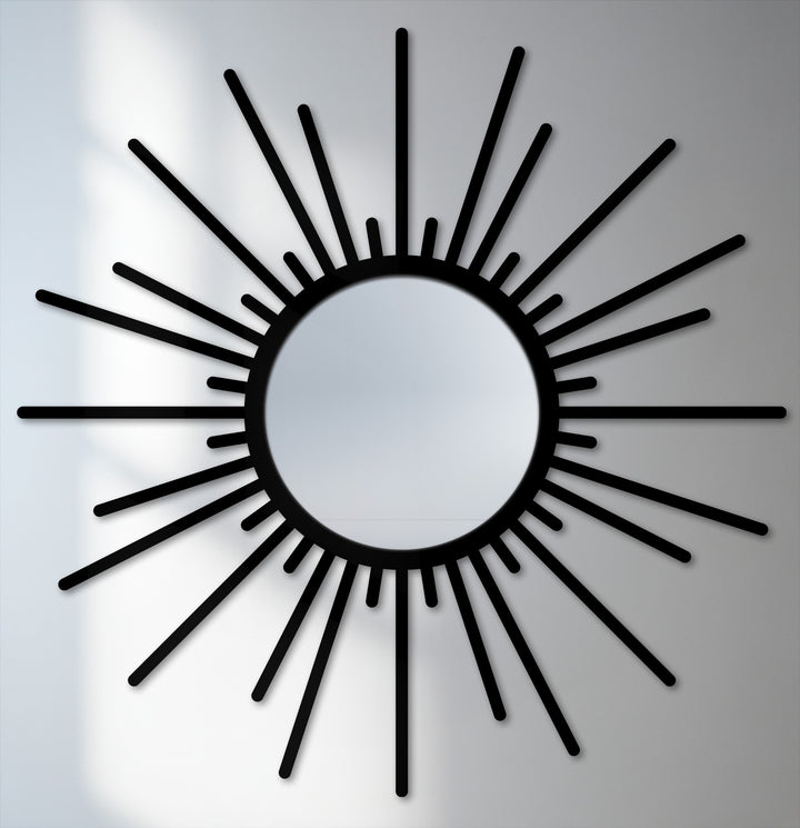 Minimal color saturation defines this modern sunburst mirror with a black frame, offering a striking example of a framed wall mirror for stylish home décor.