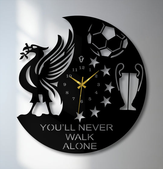 Negative space creates the silhouette of a liver bird, soccer ball, and trophy in this unique football-themed metal artwork wall clock.