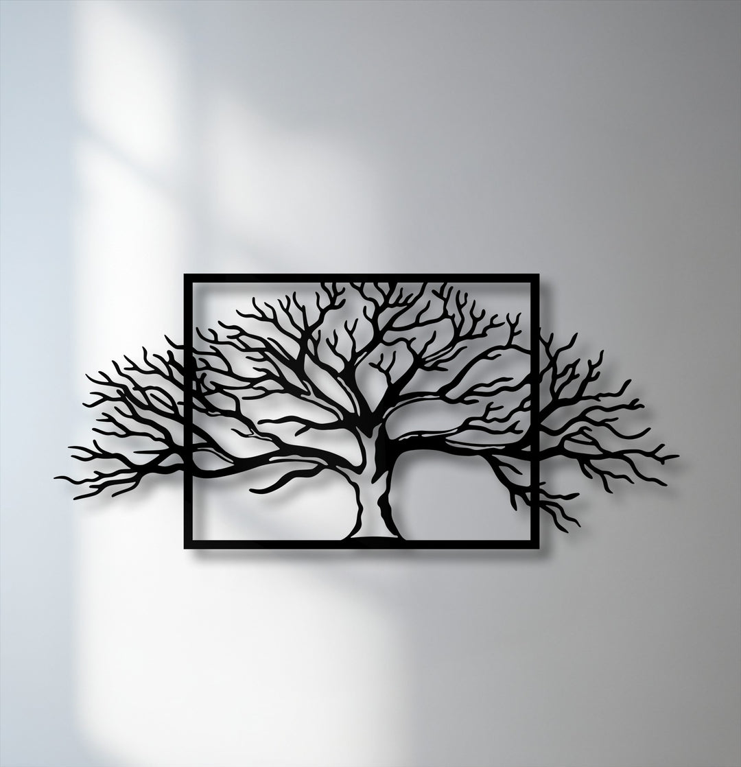 The low color saturation of this framed tree decorative metal art highlights its striking abstract nature branch design against a pale wall.