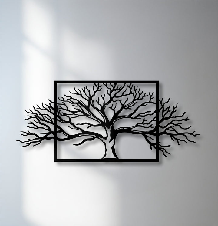 The low color saturation of this framed tree decorative metal art highlights its striking abstract nature branch design against a pale wall.