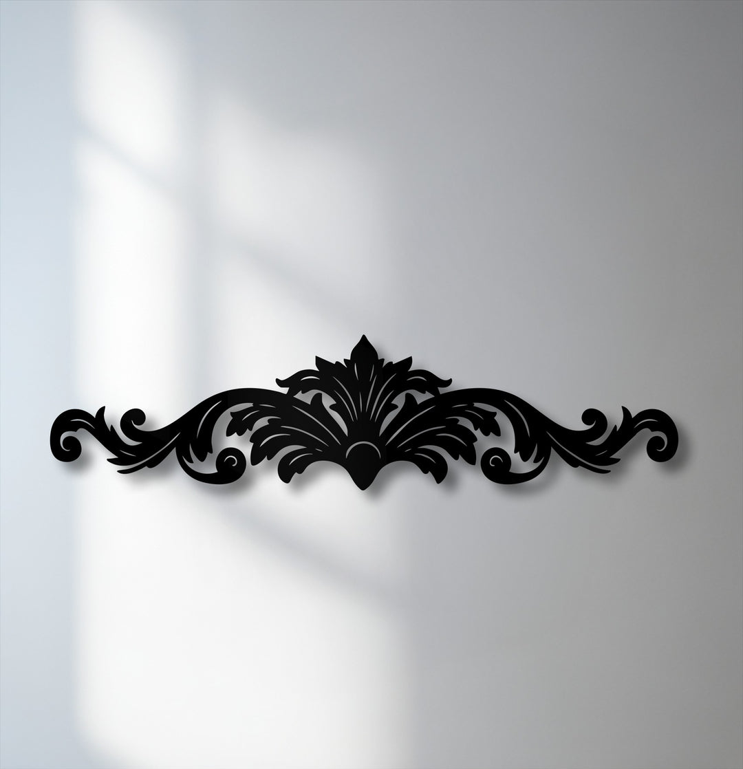 The cool color temperature of this decorative metal art highlights the elegant ornamental scroll, casting sharp shadows on the light wall.