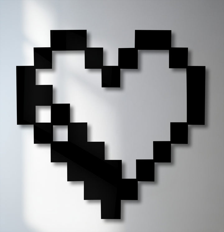 A sharp contrast between the bold black pixel heart and the light grey background creates a striking piece of decorative metal art.