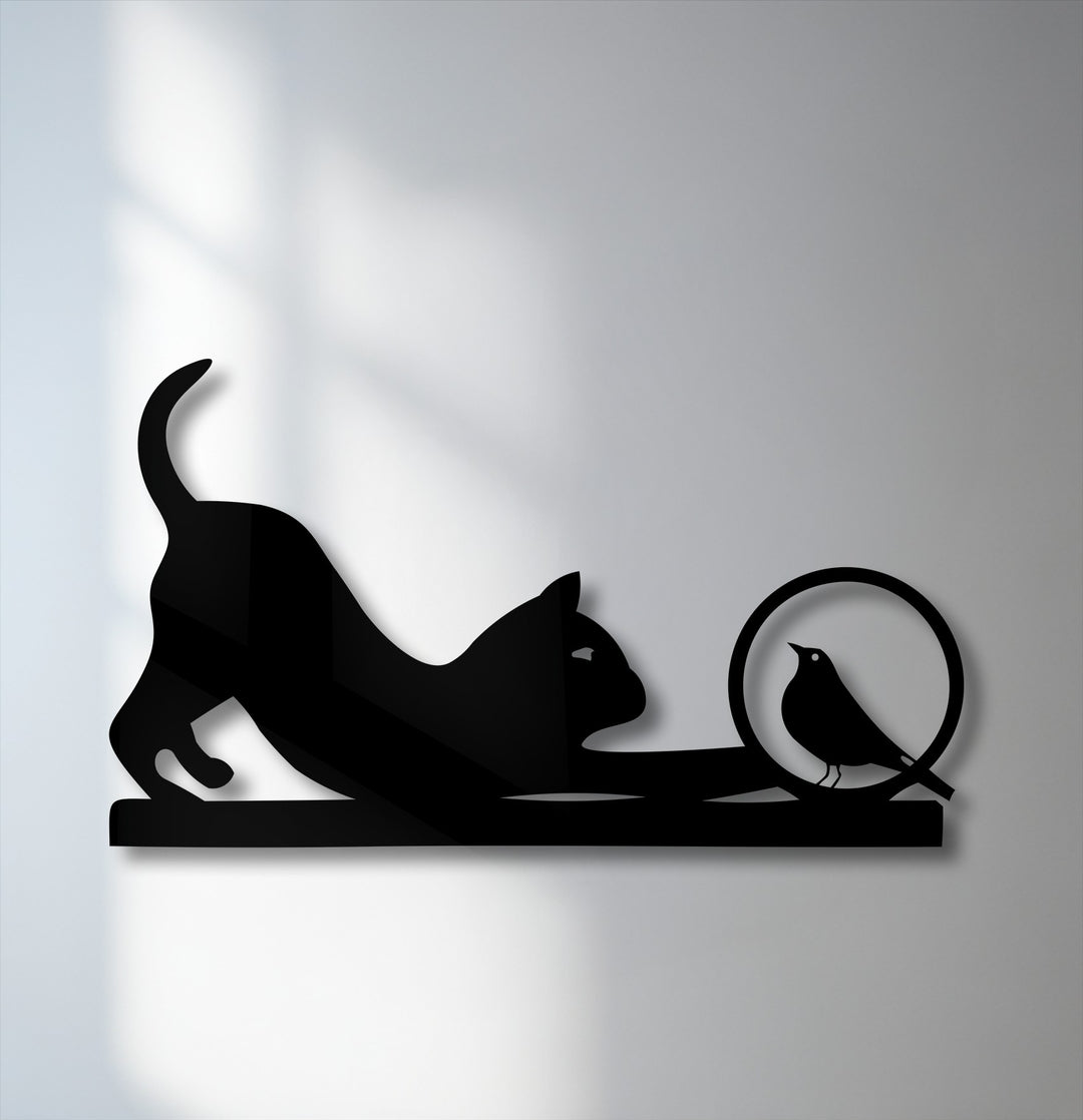 The organic forms of a playful cat stretching towards a curious bird create unique metal wall art, beautifully silhouetted.