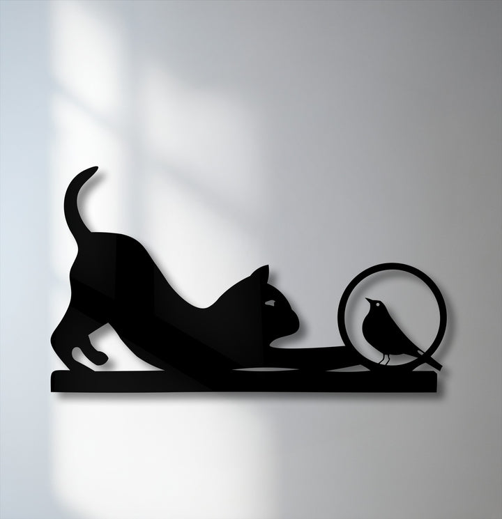The organic forms of a playful cat stretching towards a curious bird create unique metal wall art, beautifully silhouetted.