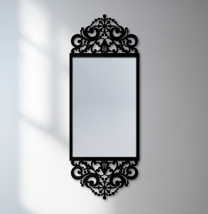 Showcasing the layering effect, the black metal scroll frame surrounds the ornate baroque mirror, presenting a striking combination of home decor and unique design.