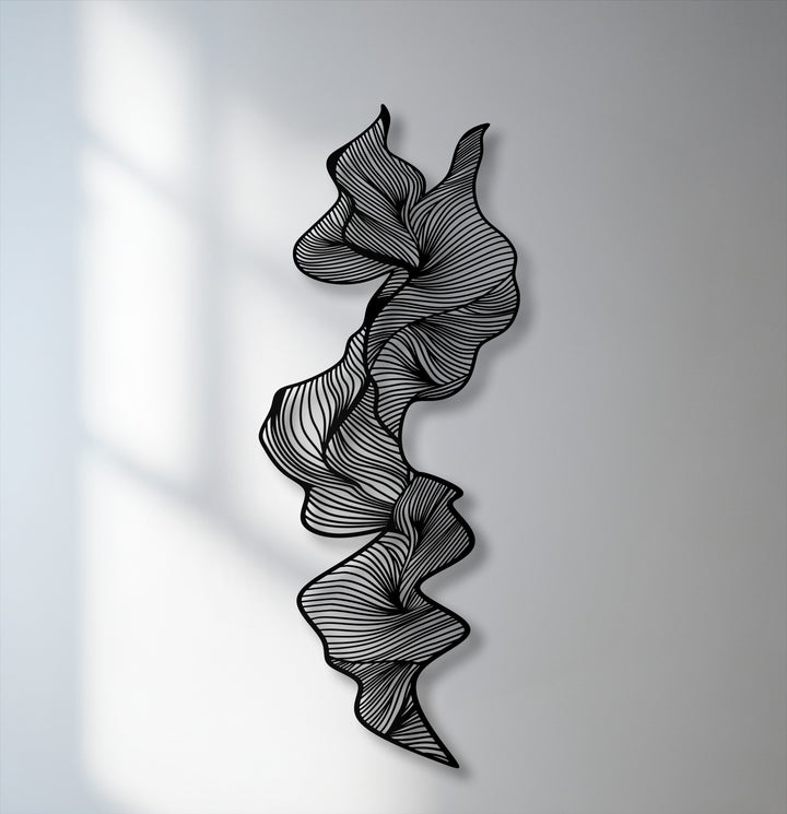 A seamless transition from bright, shadow-dappled white to soft grey wall colors accentuates the intricate, swirling lines of the metal artwork.