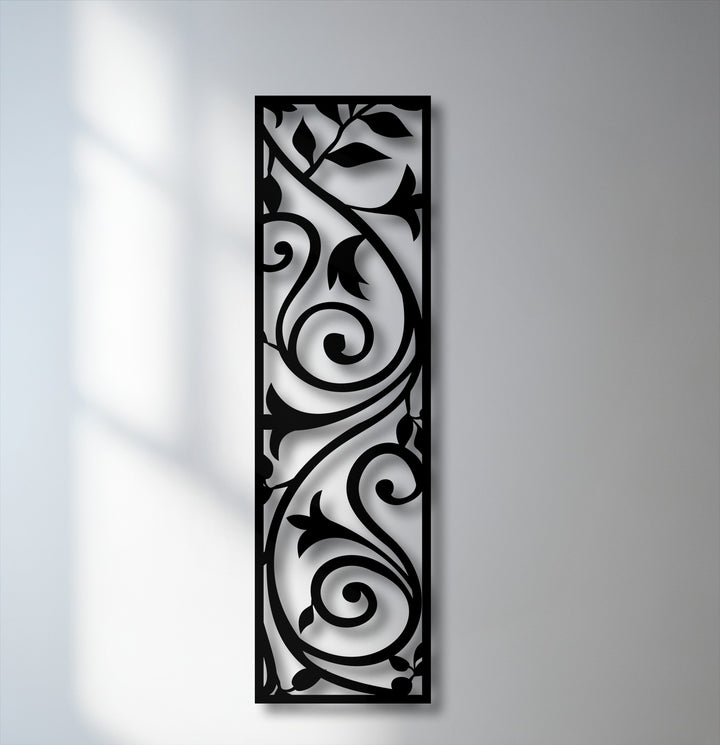Deep black decorative metal art, an elegant vertical scroll vine panel, offers stunning botanical wall decor.
