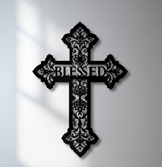 The crisp negative space vividly outlines the intricate design and 'BLESSED' text of the decorative metal art cross.