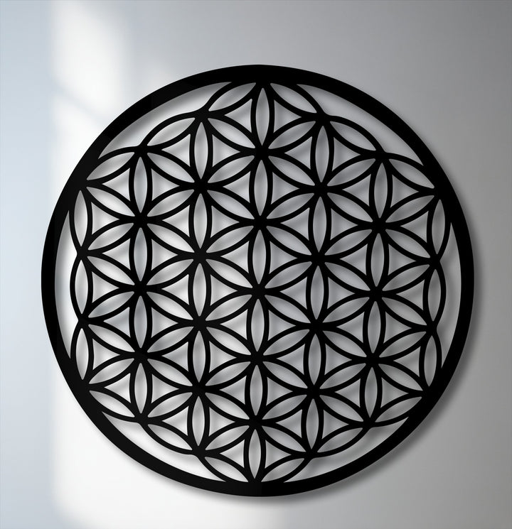 Negative space highlights the intricate Flower of Life sacred geometry as striking metal art for wall.