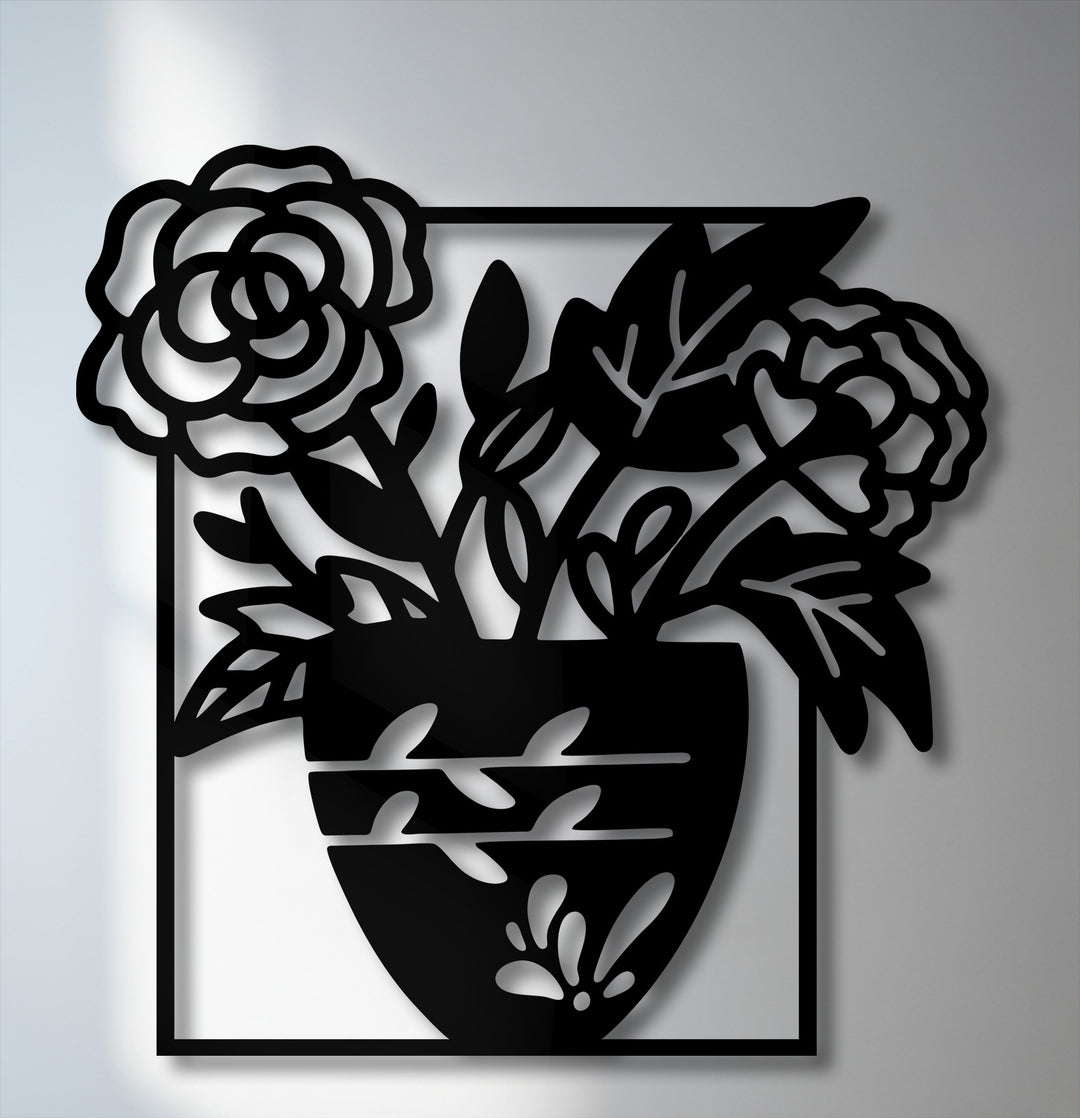 The intricate interplay of light and shadow highlights the bold floral vase silhouette in this striking metal art for wall, creating depth.