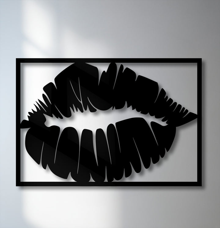 A striking black lips silhouette in decorative metal art, showcasing a bold kiss design within a framed border on a light wall.