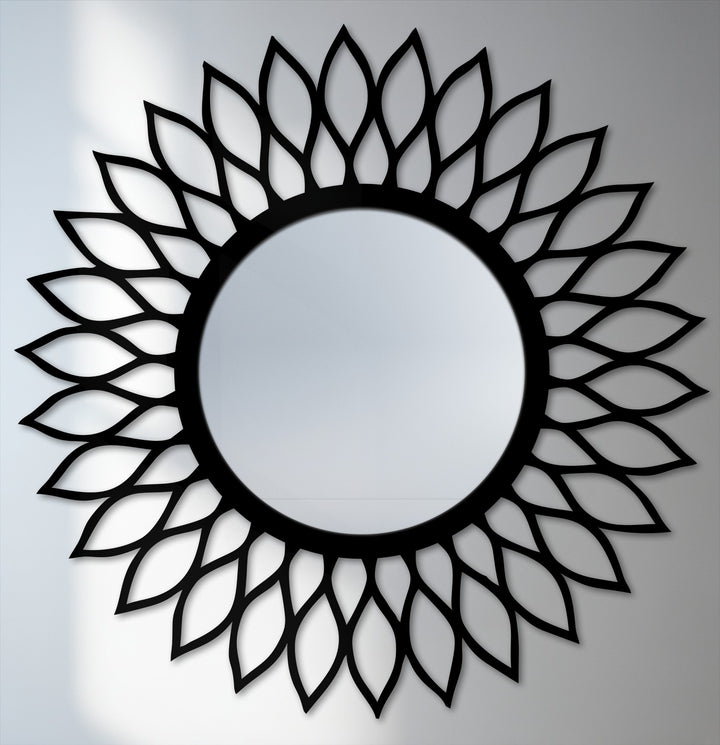 Strikingly monochrome color saturation emphasizes the elegant black leaf pattern in this round, modern mirror for wall decor.