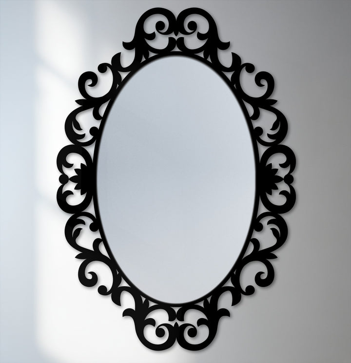 Swirling scrolls on the ornate oval frame suggest a sense of movement around this decorative bathroom mirror.