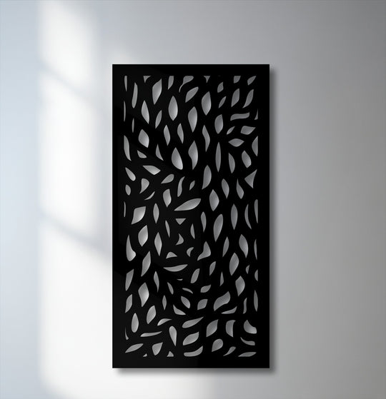 The varied surface texture of this unique metal wall art features layered cut-out abstract leaf patterns creating depth.