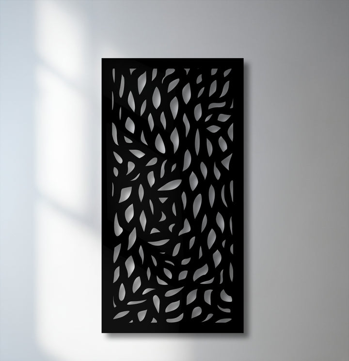The varied surface texture of this unique metal wall art features layered cut-out abstract leaf patterns creating depth.