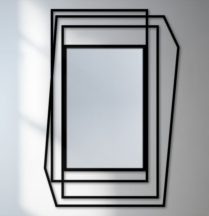 Smooth surface texture defines this modern bathroom mirror, featuring a layered geometric frame in a sleek, black metal design with an asymmetrical shape.
