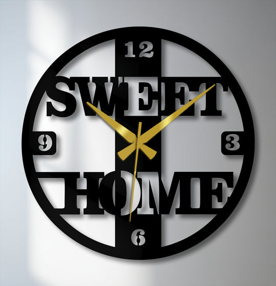 The darkest area highlights the intricate cutouts of this sweet home metal artwork clock, a modern decorative family piece.