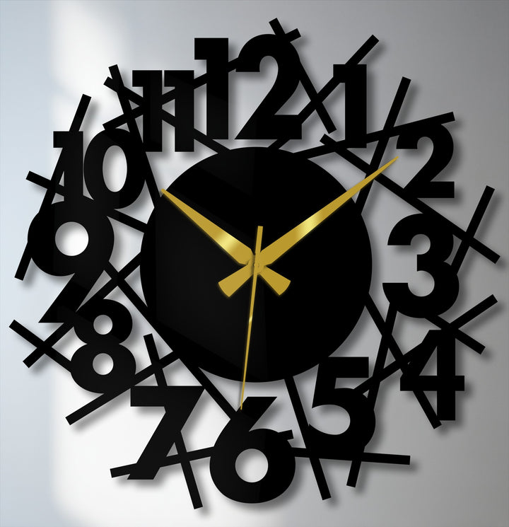 Shadowy edges soften the abstract numeric chaos of this modern metal wall clock, creating a unique metal wall art piece with scattered numbers and gold hands.