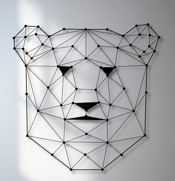 The foreground detail reveals a striking geometric bear face, crafted from interconnected black lines and dots, creating unique metal art for wall decor.