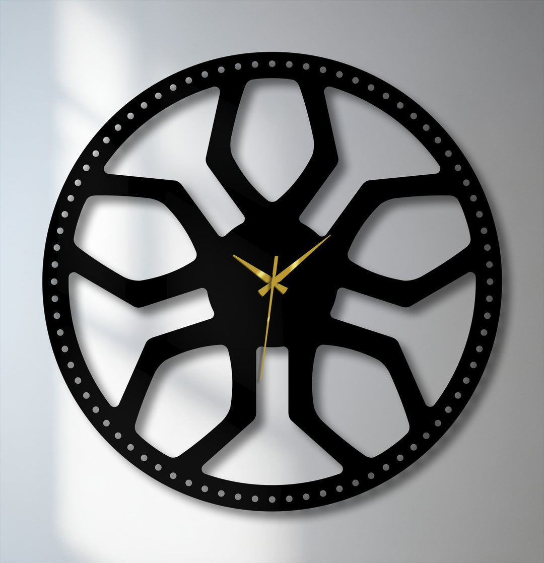 Subtle light and shadow define the intricate black metal abstract radial pattern of this modern geometric decoration wall art clock.