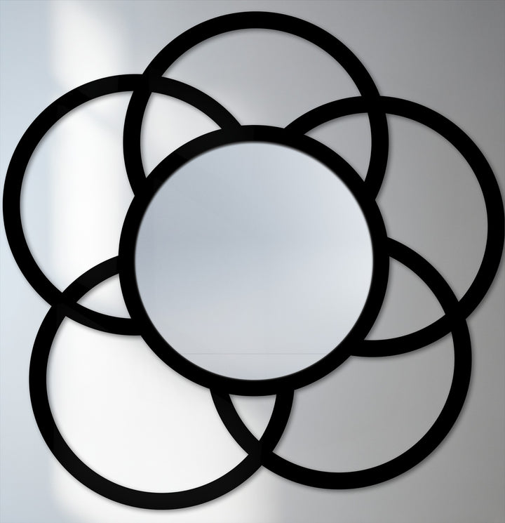 Showcasing the realistic detail of the modern interlock circle floor mirror's decorative metal art, highlighting its meticulously crafted interlocking black frame.