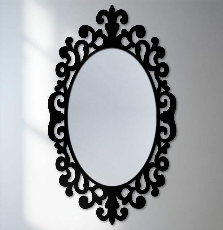 The darkest area defines the intricate scrollwork frame of this Imperial scroll accent oval floor modern mirror, casting a bold silhouette against the mirrored glass.