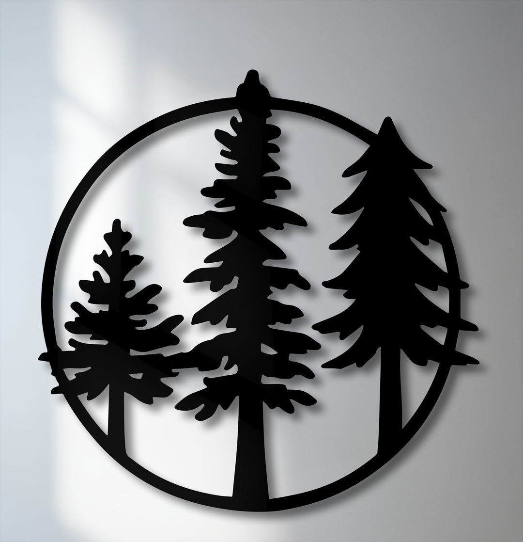 The prominent black silhouette of three evergreen pine trees within a circular frame makes for striking metal art for wall decor.