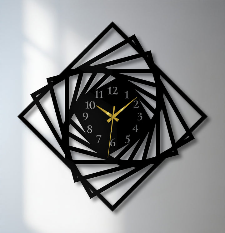 Negative space intricately reveals the dynamic spiral geometric design of this modern black metal art for wall clock.