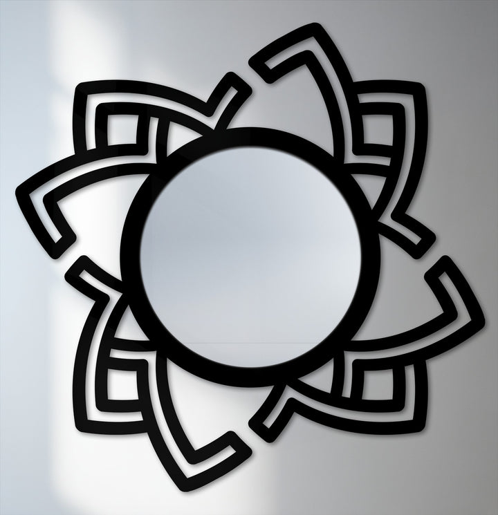 Negative space defines the bold, abstract rotating frame, creating a striking decoration wall art design within this modern metal wall mirror.