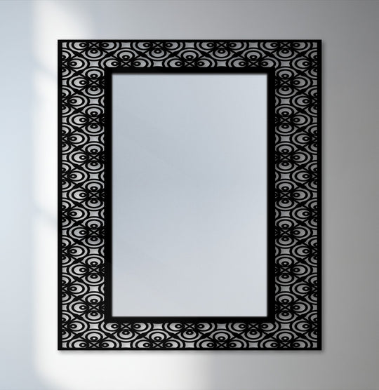 The focal point highlights the ornamental circular pattern of this decorative mirror, framed in black metal for a bold and stylish statement.
