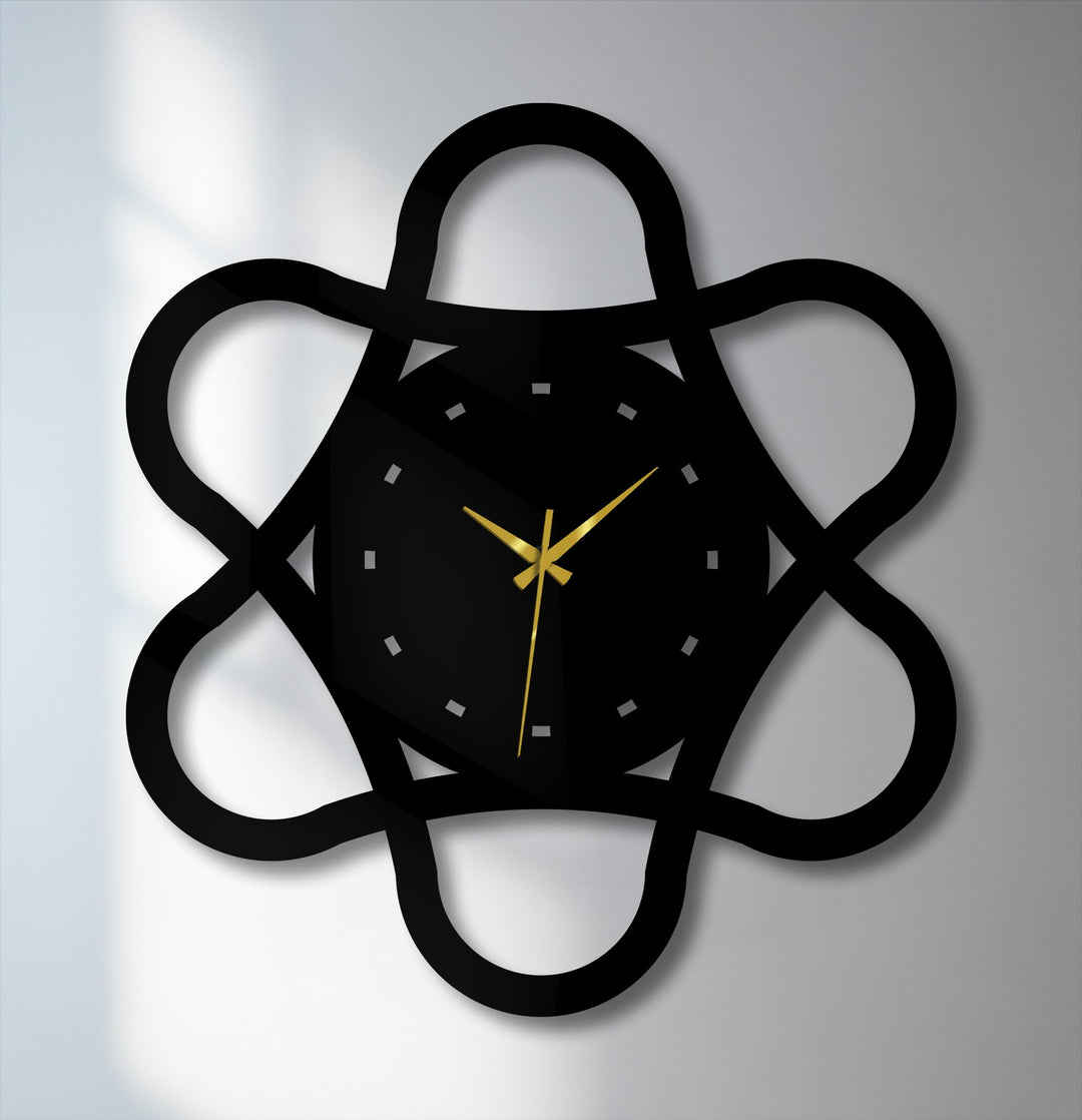 Moody and modern, this black metal loop geometry wall clock evokes a contemporary feel with its abstract design and geometric metal artwork.
