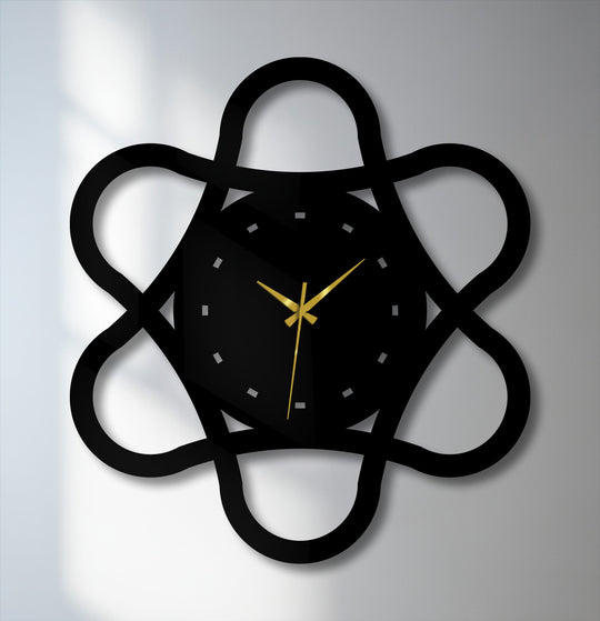 Moody and modern, this black metal loop geometry wall clock evokes a contemporary feel with its abstract design and geometric metal artwork.