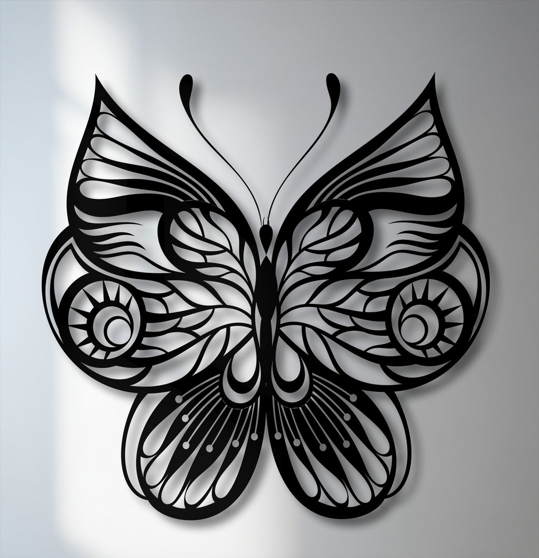 The soft, light gray background features subtle shadows cast by the unique metal wall art, an ornate decorative butterfly design.