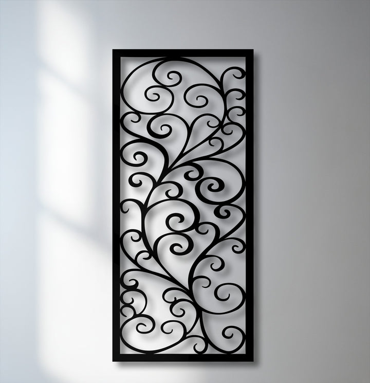 The ornate scroll pattern of the black metal wall decor features elegant swirls and intricate branches.