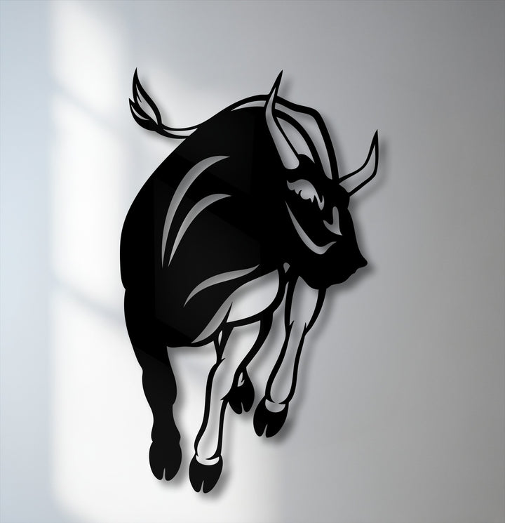 The dynamic silhouette of a charging bull features a bold geometric design with sharp angles and fluid curves, making striking metal artwork.