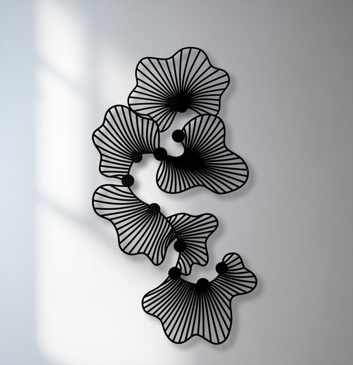 The sleek matte black finish of this unique metal wall art perfectly highlights its modern abstract floral line design.