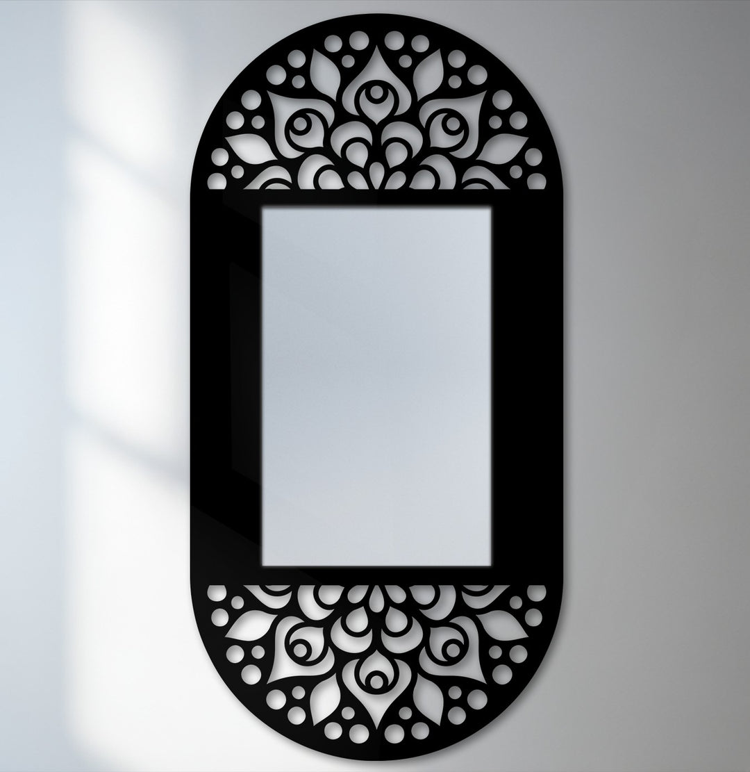 Darkest area highlighting the mandala floral pattern on the black metal frame of this decorative oval mirror for wall decor, creating an elegant and artistic focal point.