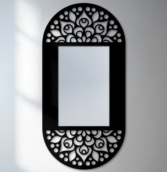Darkest area highlighting the mandala floral pattern on the black metal frame of this decorative oval mirror for wall decor, creating an elegant and artistic focal point.
